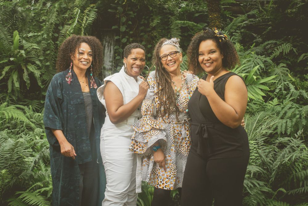 Four women infront of plants.